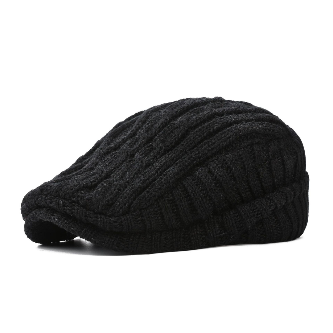 Close-up of a textured cable knit flat cap, showcasing the intricate knit details. Classic unisex style.