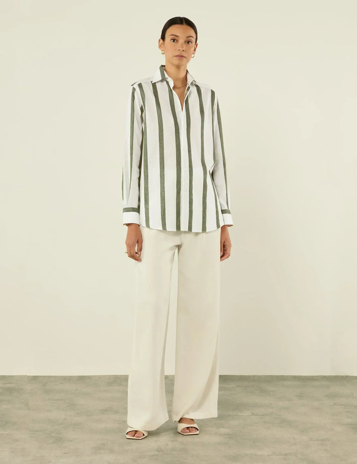 Close-up of a relaxed fit unisex khaki shirt featuring subtle stripes and a classic button-up front.
