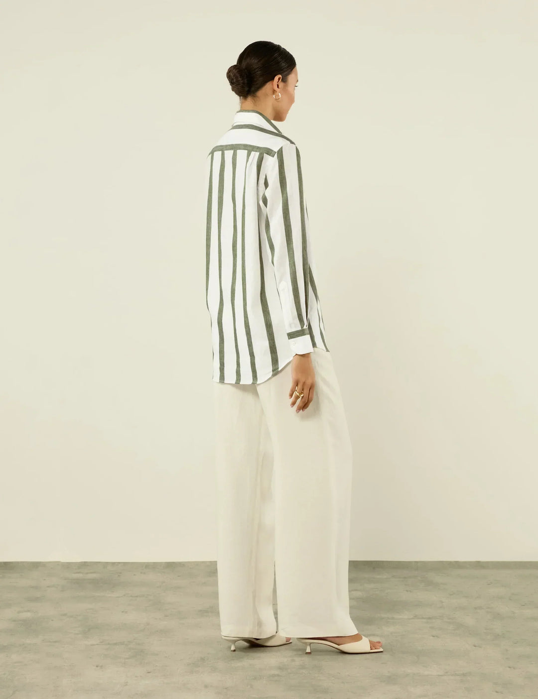 Khaki striped button-up shirt, unisex with a relaxed fit. Ideal for comfortable, casual everyday wear.