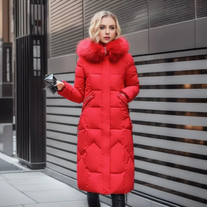 Model wearing the unisex long hooded winter parka in a snowy landscape, demonstrating its snow protection features.