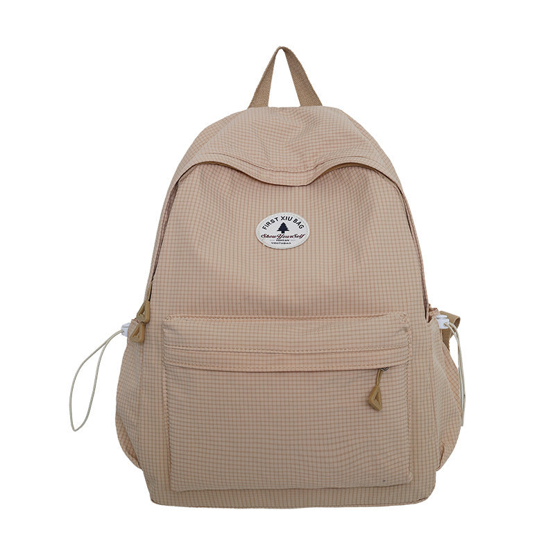 Close-up of multi-compartment student backpack, showing spacious pockets for books, laptop, and school supplies.