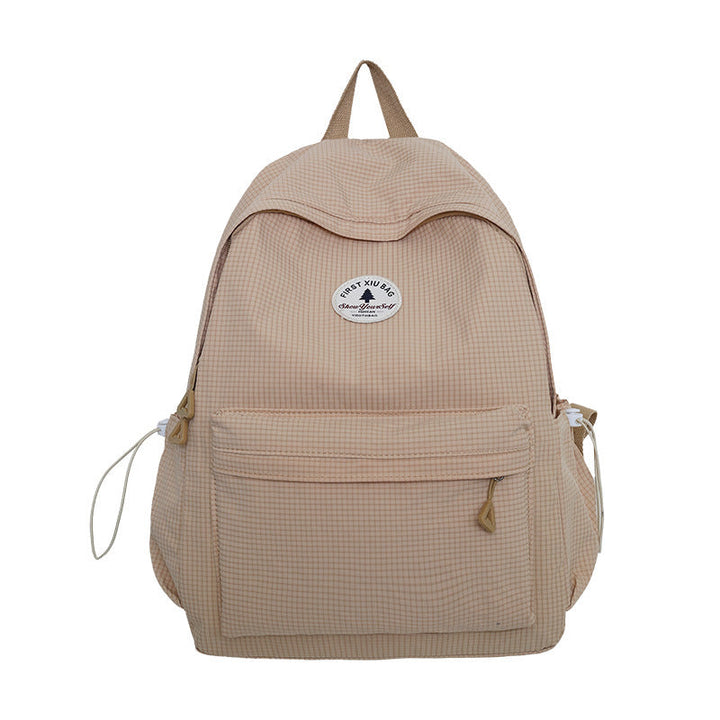 Close-up of multi-compartment student backpack, showing spacious pockets for books, laptop, and school supplies.