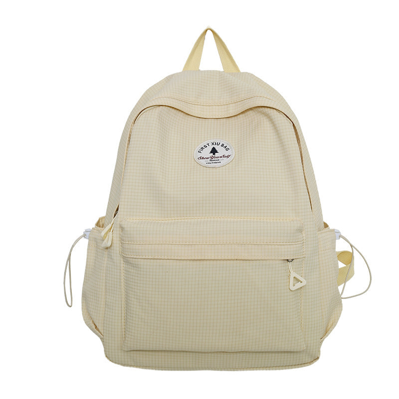 Student wearing a casual multi-compartment backpack, perfect for school, daily carry, and short travel trips.