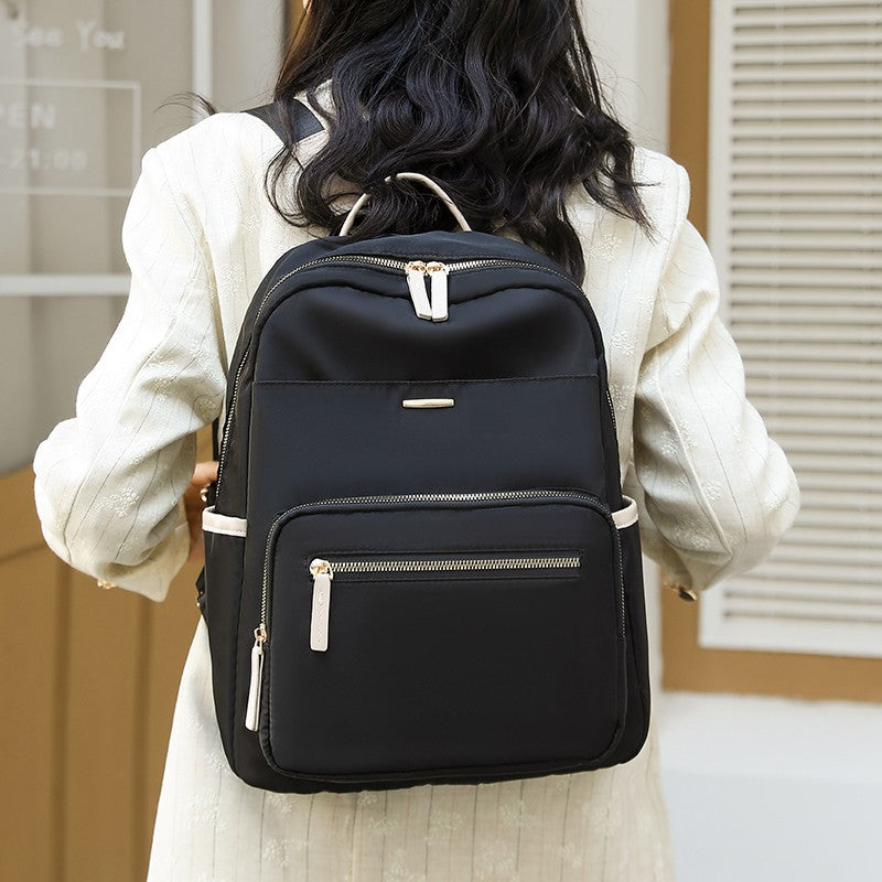 Durable water-resistant multi-pocket travel backpack, side view with convenient bottle & quick-access pockets.
