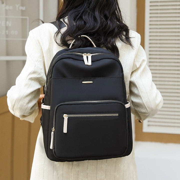 Durable water-resistant multi-pocket travel backpack, side view with convenient bottle & quick-access pockets.