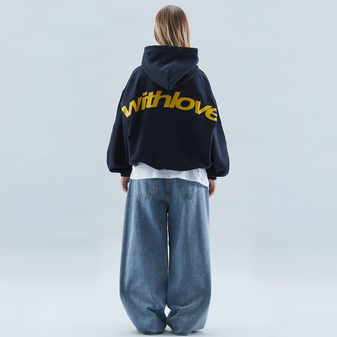 Plush oversized unisex hoodie in black, 'Withlove' slogan print, comfortable pullover for everyday wear.