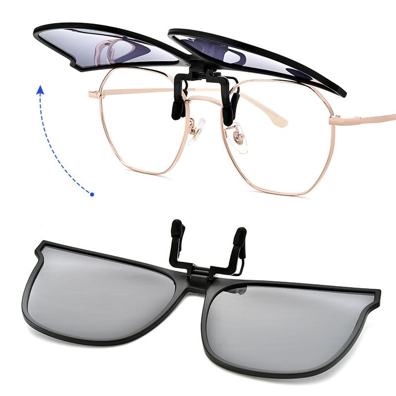 Close-up of polarized flip-up clip-on sunglasses. Features UV400 eye protection & glare reduction for clear vision.