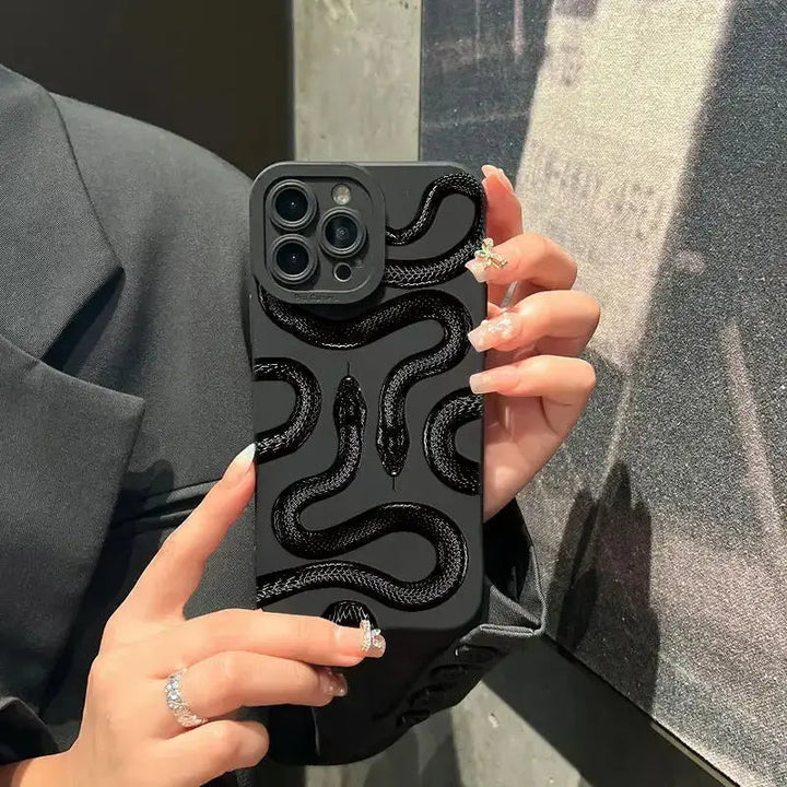 Hand holding a slim, shock-absorbing phone case with a unique snake pattern, a stylish accessory.
