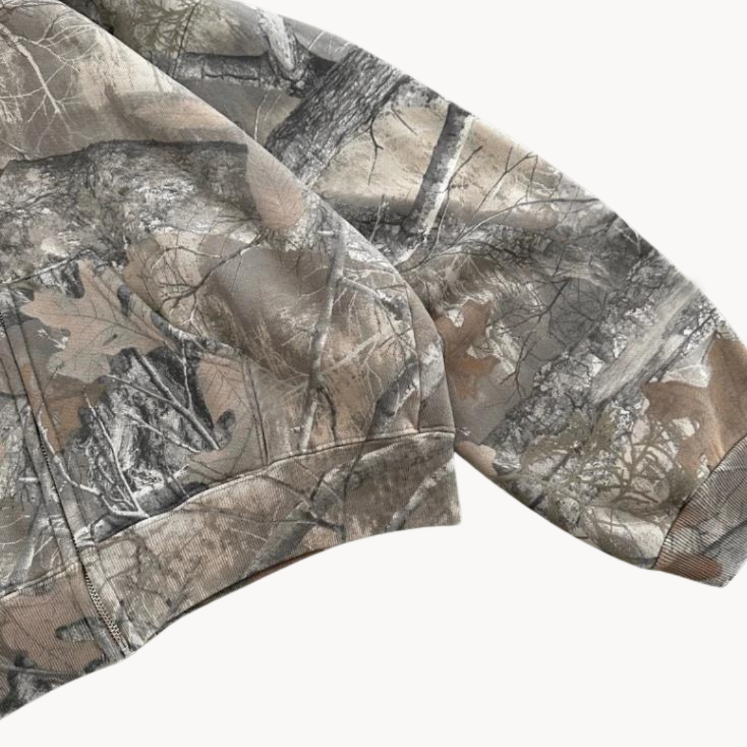Stylish urban camo hooded sweatshirt, oversized for a modern streetwear aesthetic. Versatile camouflage top.