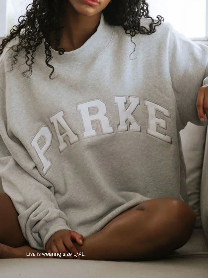 Unisex comfort hoodie, oversized varsity style with soft chenille lettering.