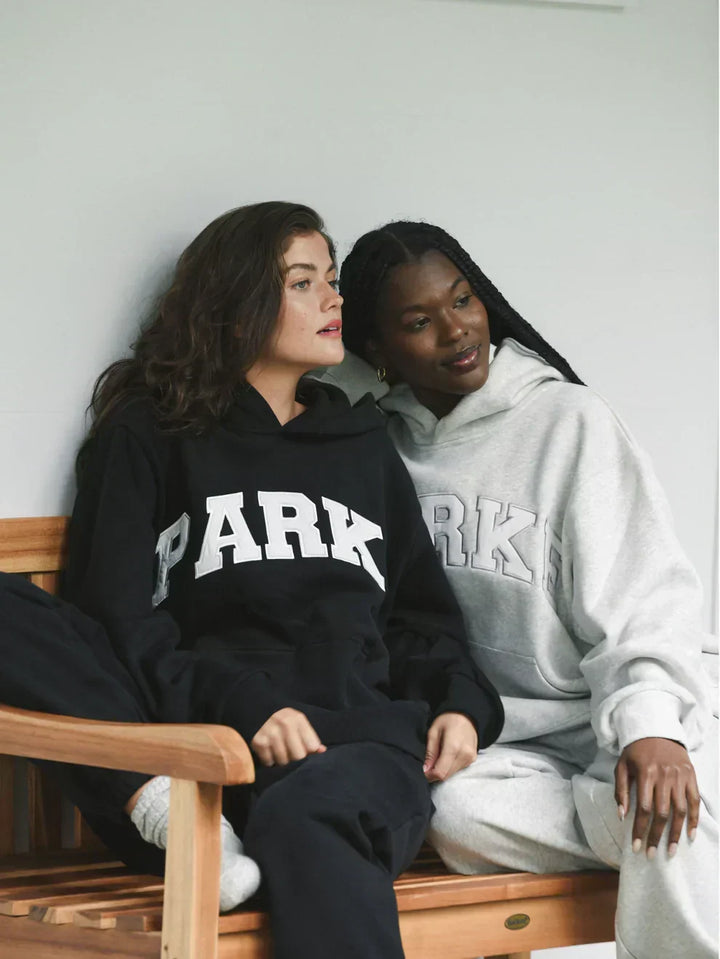Super cozy unisex hoodie, chenille varsity letters for a relaxed, stylish look.