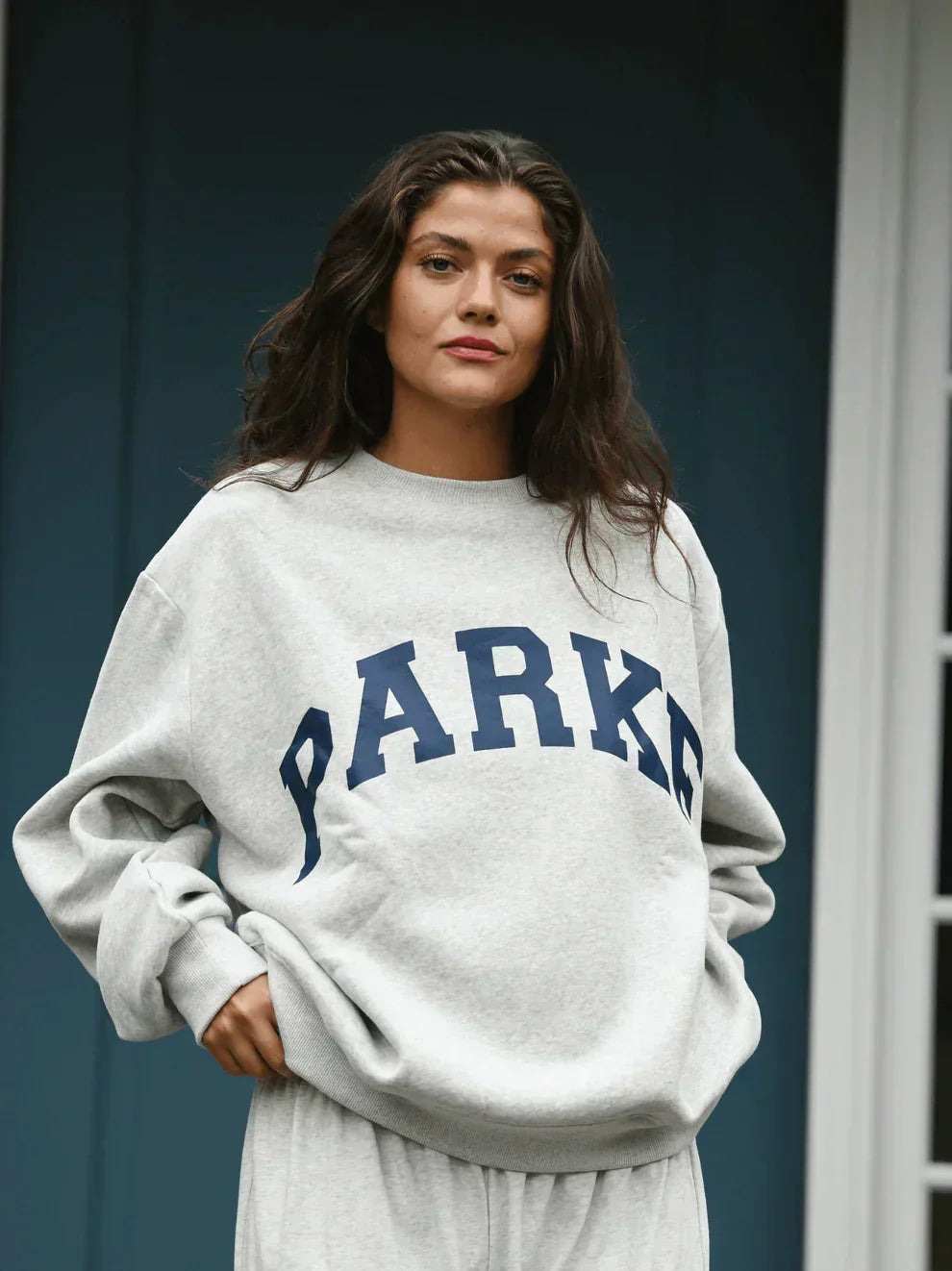Comfortable varsity sweatshirt with soft chenille lettering, oversized and cozy.