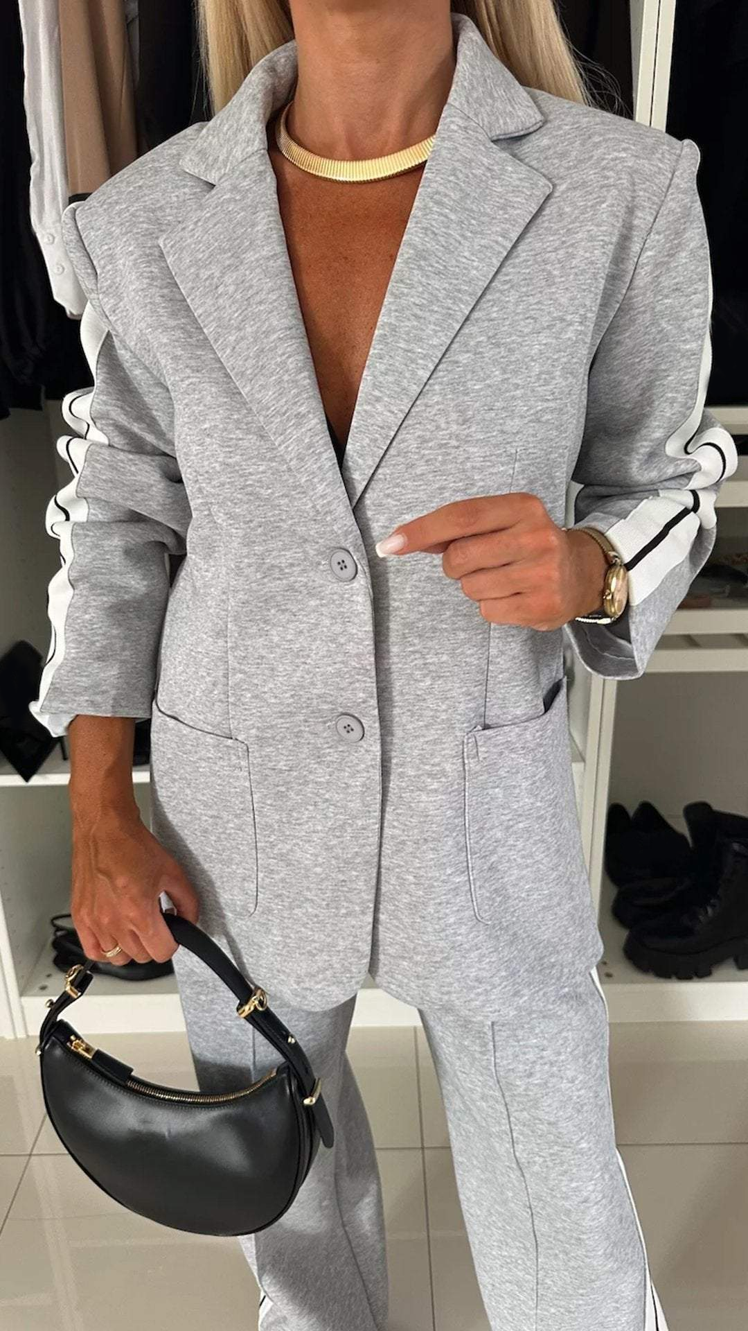 Detail of the tailored fit of the Urban Luxe women's sporty chic two-piece suit.