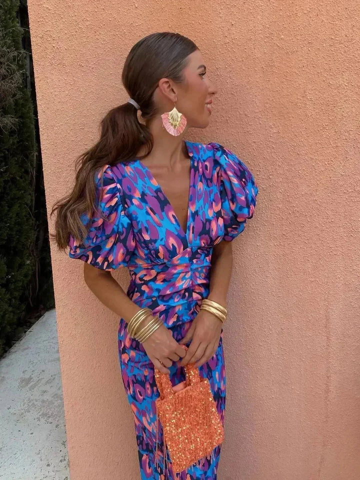Vibrant abstract print women's midi dress with elegant puff sleeves and a flattering V-neck, perfect for evening wear.