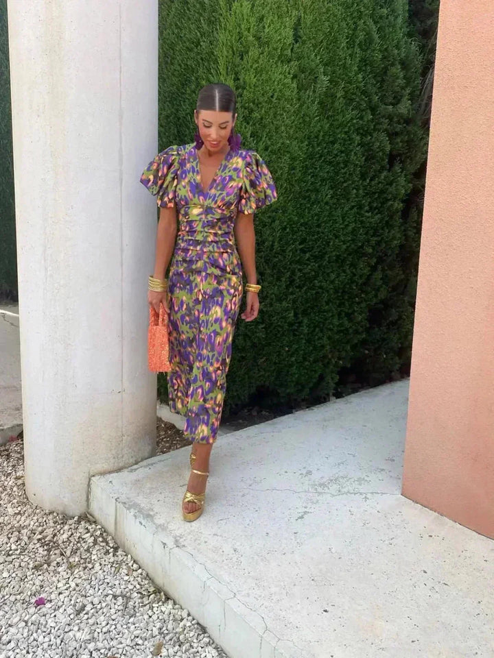 Elegant women's vibrant abstract print midi dress with puff sleeves and a V-neck, ideal for fashion-forward evening wear.