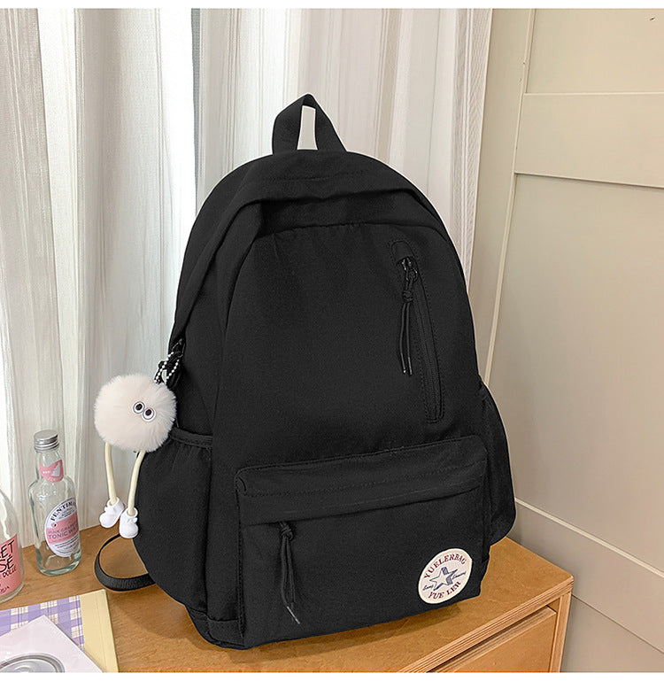 Spacious utility backpack in a modern design, showing side mesh pocket for water bottles, ideal for school & travel.