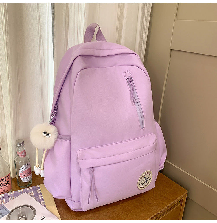 Durable, lightweight fabric utility backpack with sturdy zippers, perfect for daily school commutes and travel adventures.