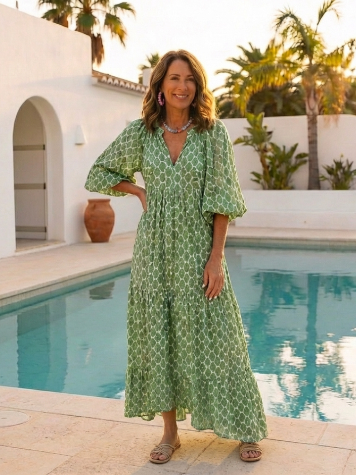 Stylish women's V-neck midi dress, featuring a vibrant pattern and comfortable three-quarter sleeves.