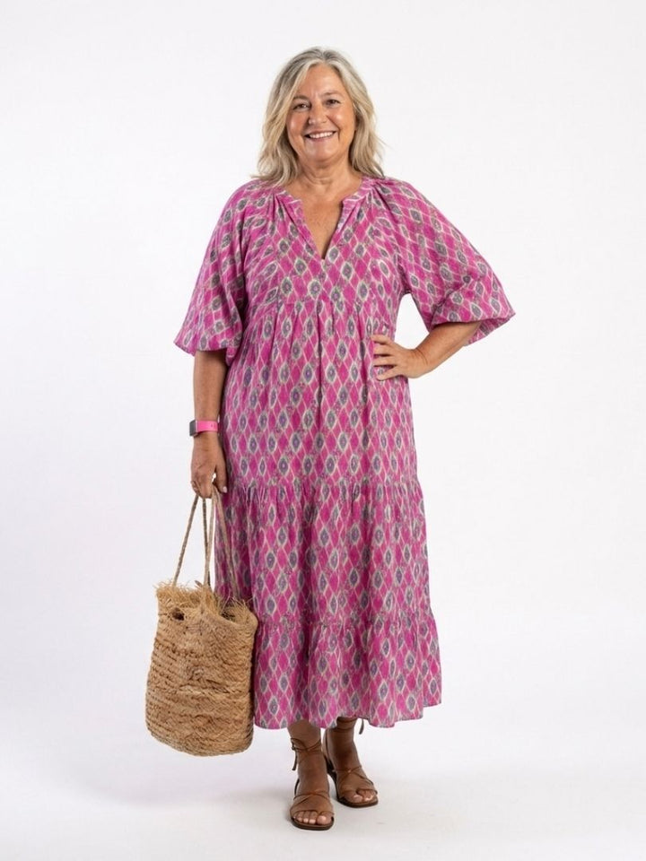 Green patterned V-neck midi dress, relaxed fit with three-quarter sleeves and a charming tiered skirt.