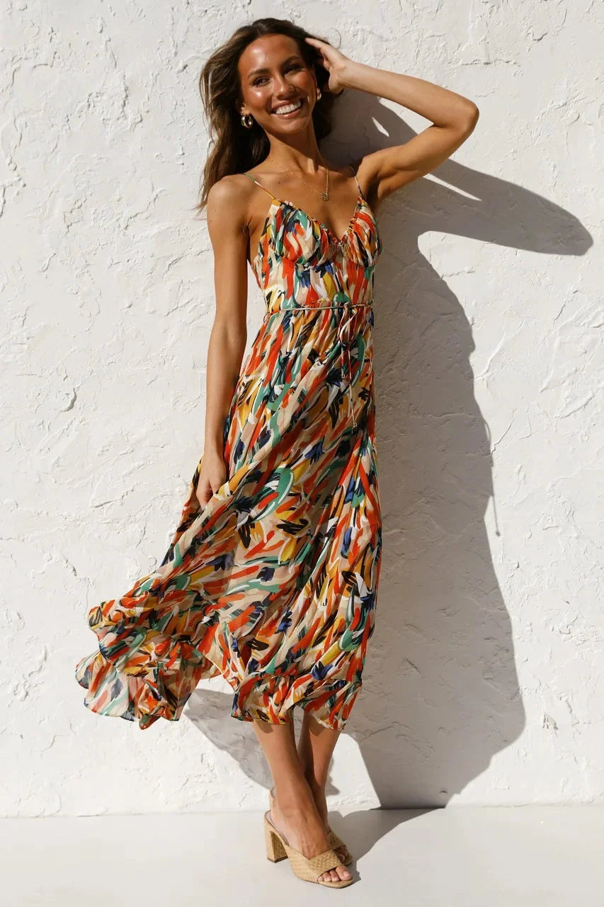 Flowy sleeveless v-neck midi dress featuring vibrant abstract print. Comfortable women's casual summer fashion style.