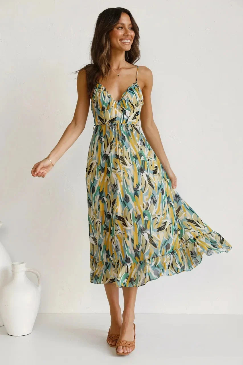 Close-up of vibrant abstract print on a women's flowy v-neck sleeveless midi dress. Trendy summer style fashion.