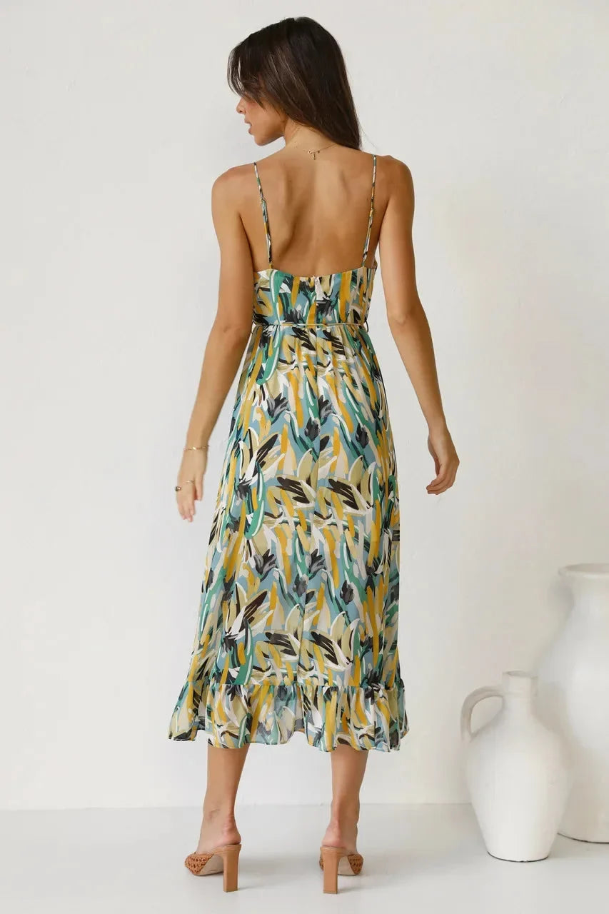 Woman modeling a colorful abstract print v-neck sleeveless midi dress, showcasing its flowy summer casual style.