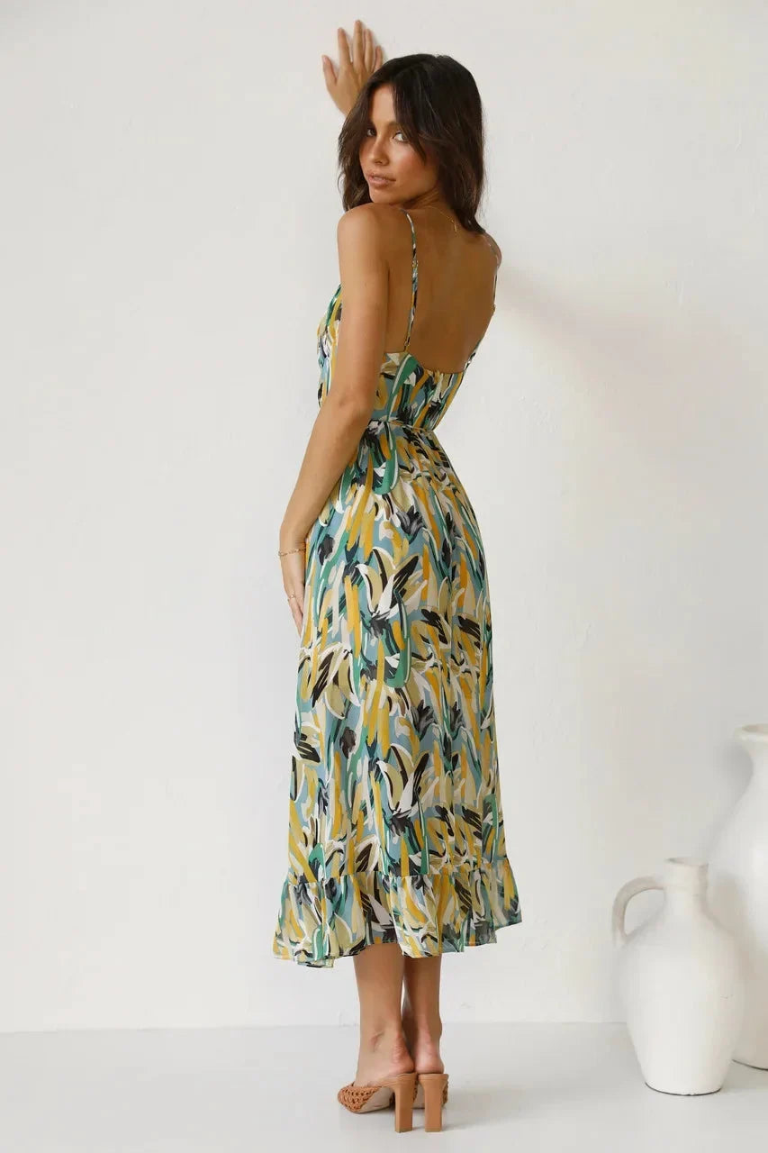 Stylish women's colorful abstract print v-neck sleeveless midi dress, highlighting its flowy silhouette. Summer ready.