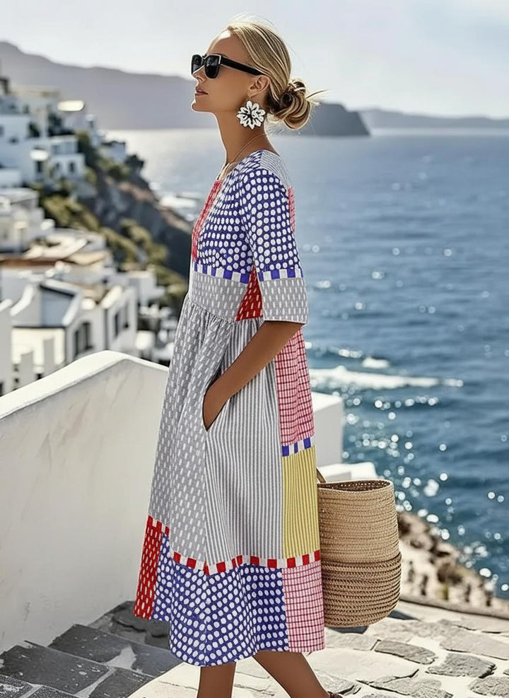 Women's vibrant A-line midi dress featuring a stylish color block geometric print, round neck, and short sleeves.