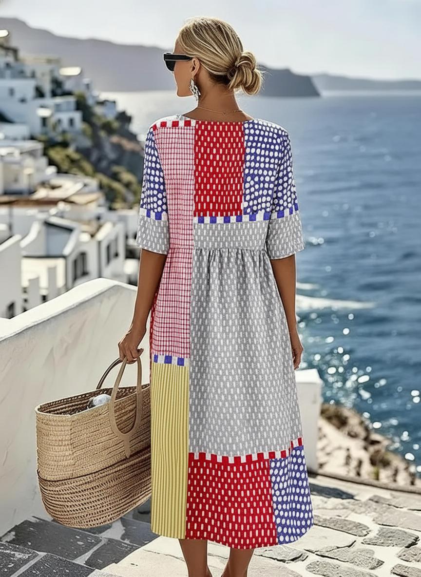 Casual women's vibrant geometric color block midi dress. A-line fit with an empire waist, short sleeves & pockets.