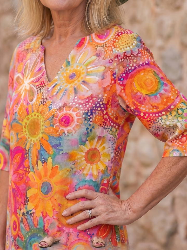 Women's vibrant floral knee-length dress, relaxed fit, V-neck, short sleeve, ideal for comfortable casual wear.