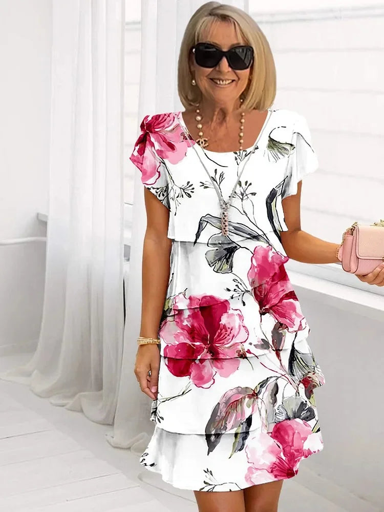 Vibrant women's floral tiered dress with flutter short sleeves, perfect for summer casual wear. Relaxed fit midi style.