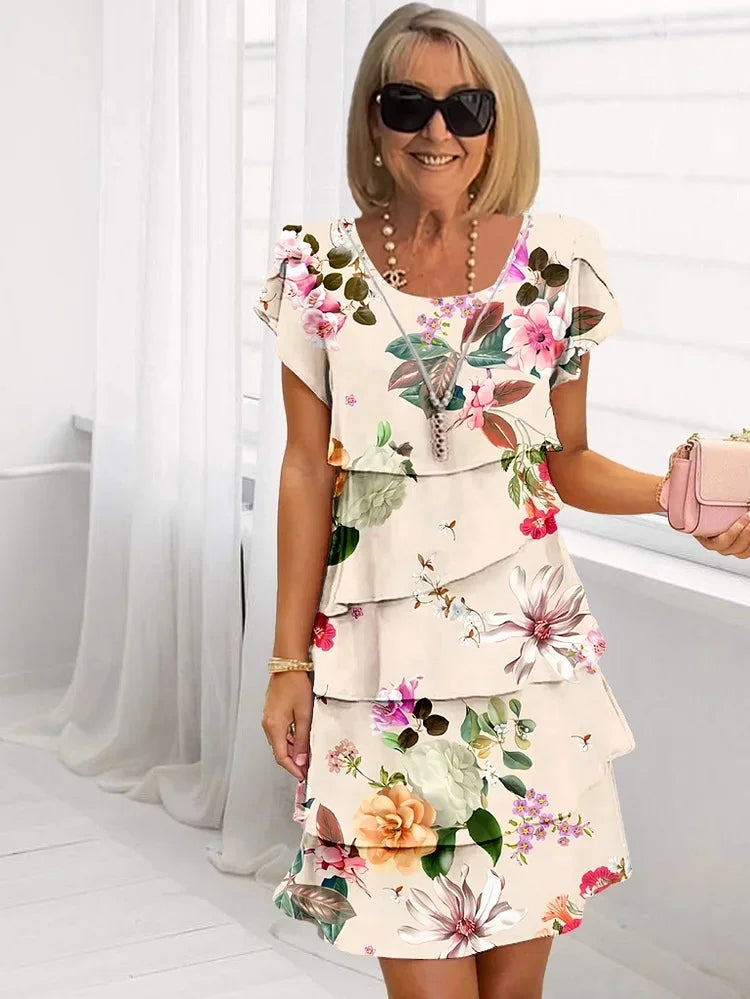 Chic women's short sleeve floral dress with tiered skirt and delicate flutter sleeves. Ideal for vibrant summer style.