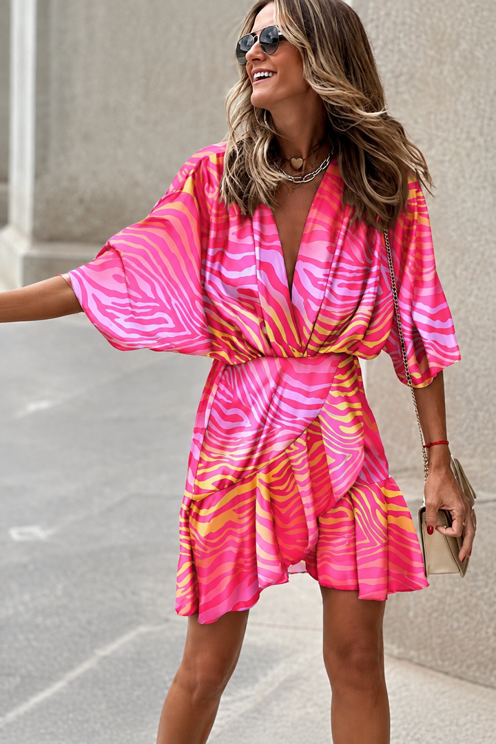 Vibrant women's V-neck paisley print mini dress. Ideal for summer, casual wear, or bohemian party fashion. Short sleeve & flowy.