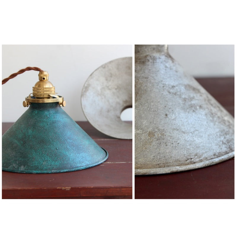 Decorative metal cone shade pendant light, a vintage accent for modern interior design.