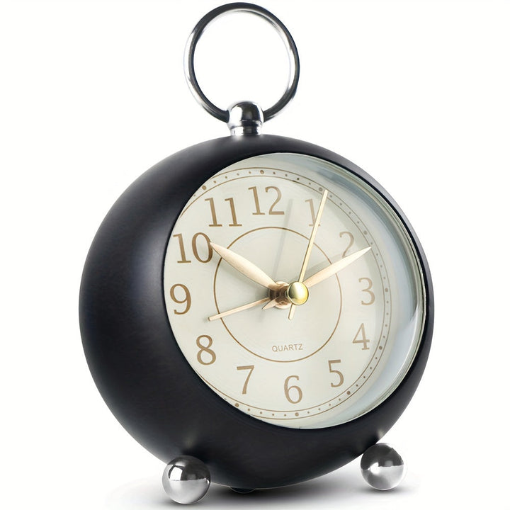 A vintage cyan analogue alarm clock with a functional night light
