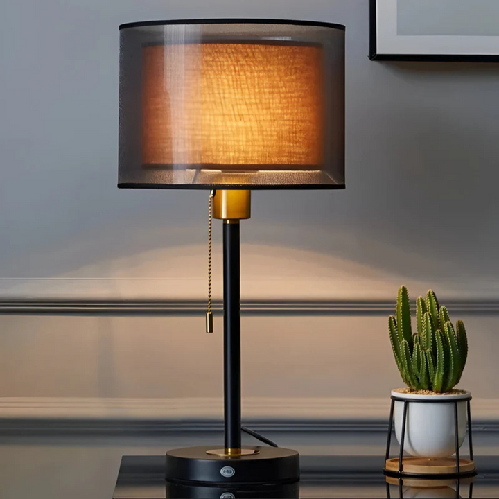 Vintage double fabric shade table lamp, warm ambient light, black bronze finish.