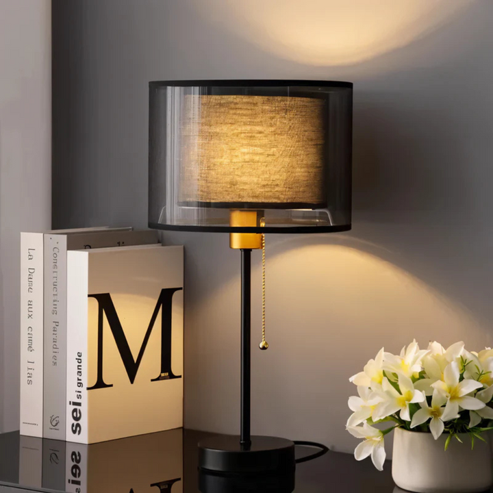 Bedroom decor: vintage double fabric shade table lamp casting warm, inviting light.