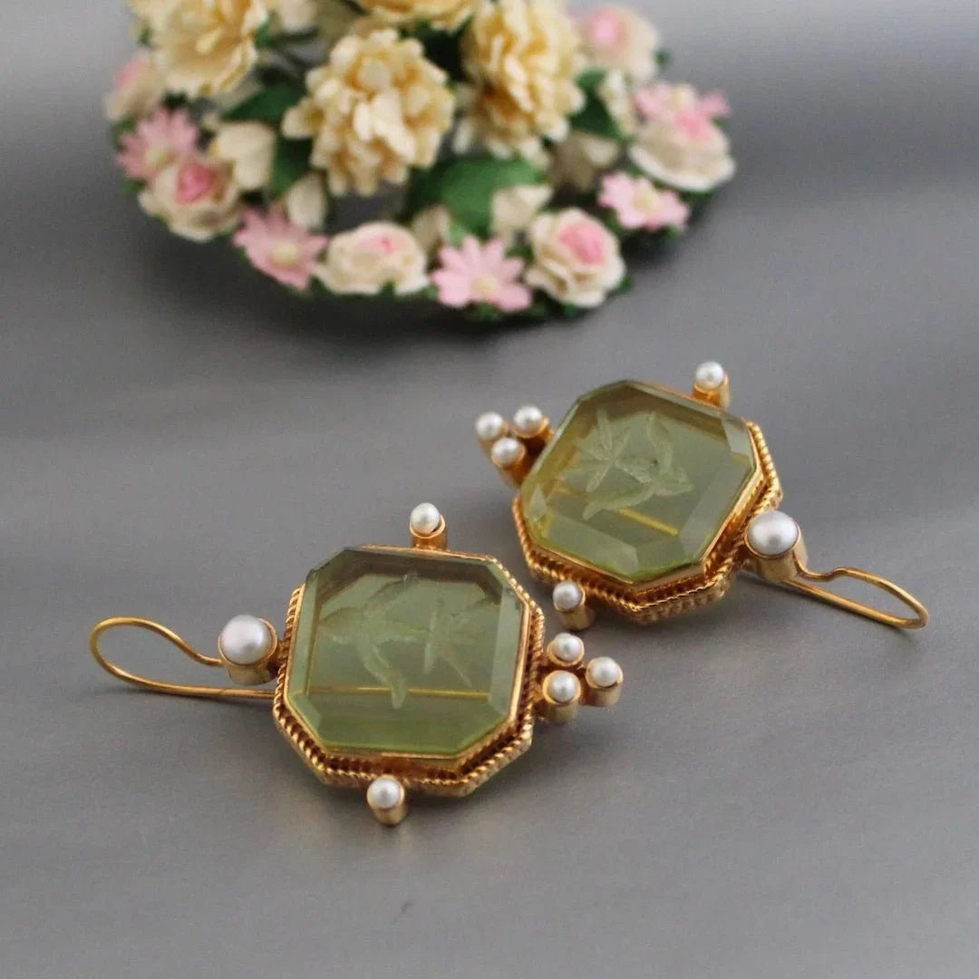 Elegant women's vintage gold-tone octagonal earrings with a prominent green stone. Stylish fashion jewelry gift.