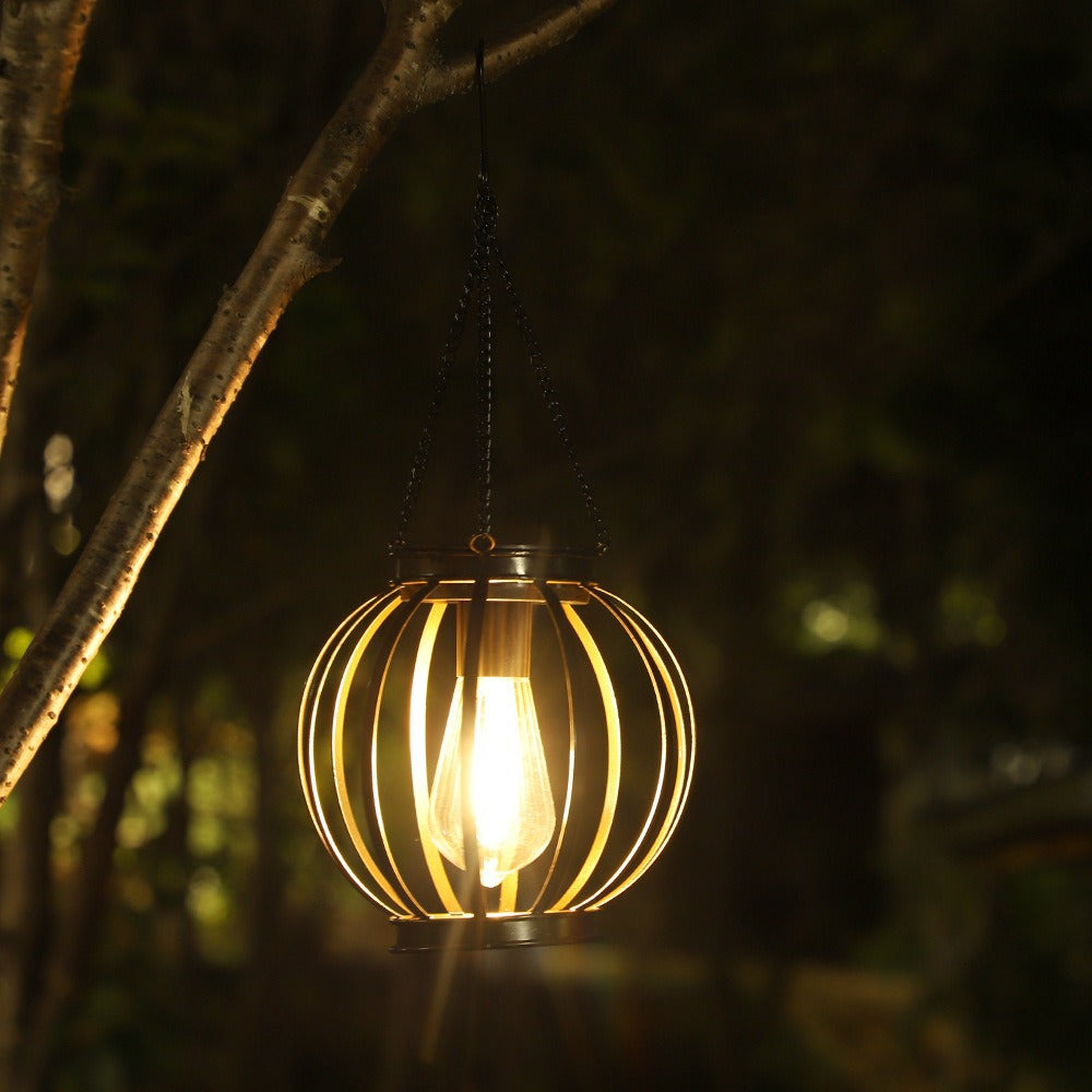 Stylish vintage LED solar hanging lantern, metal cage, perfect for waterproof outdoor garden lighting.