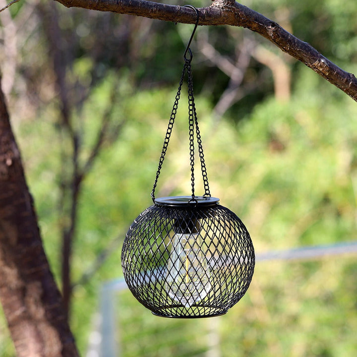 Hanging outdoor solar lantern, vintage LED filament, waterproof metal cage for garden & patio lighting.