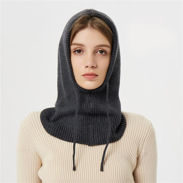 Adjustable hooded beanie made from warm, insulating knit material for winter.