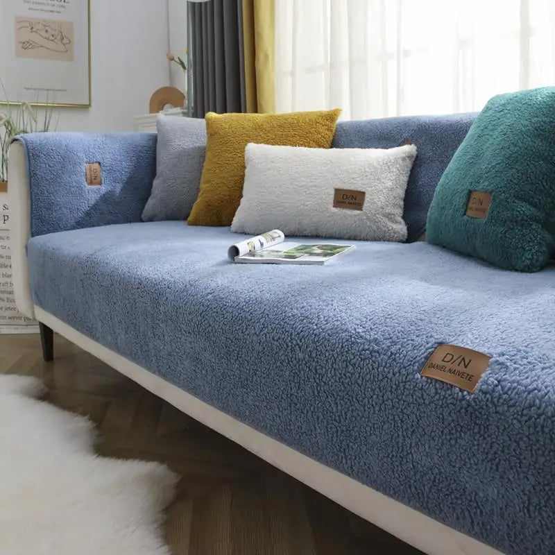 Non-slip waterproof sofa cover on a three-seater, ensuring secure fit & protecting furniture from spills, pets, and wear.