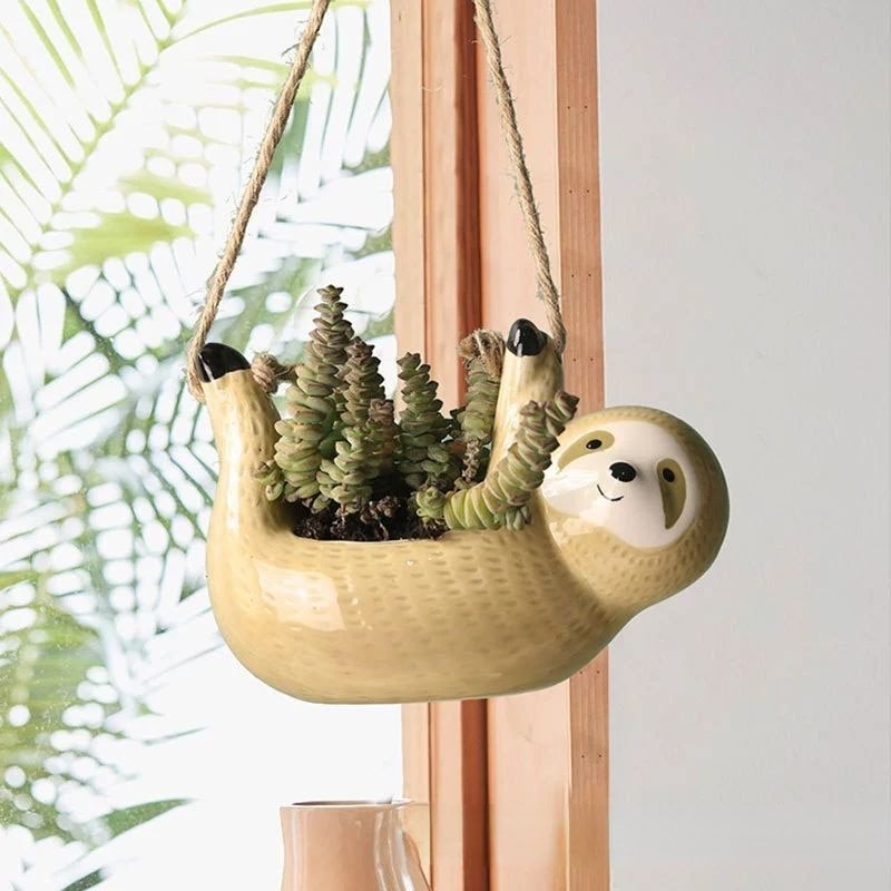 Adorable sloth ceramic hanging planter, an ideal gift idea for plant lovers. Perfect indoor succulent holder.