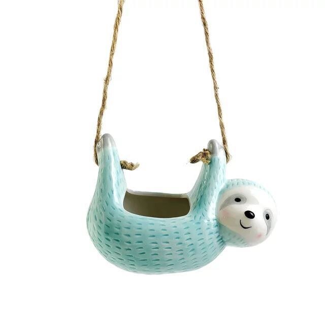 Decorative ceramic sloth hanging planter, brings whimsical animal decor to your indoor plant collection.