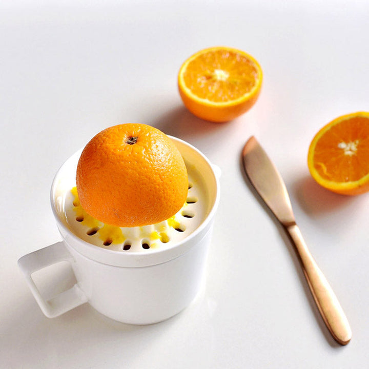 Unisex ceramic lemon squeezer & orange press, designed for effortless manual juicing in any home kitchen.
