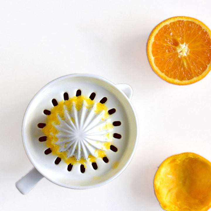 Ceramic manual lemon squeezer. Enjoy fresh, healthy citrus drinks quickly with this easy-clean kitchen gadget.