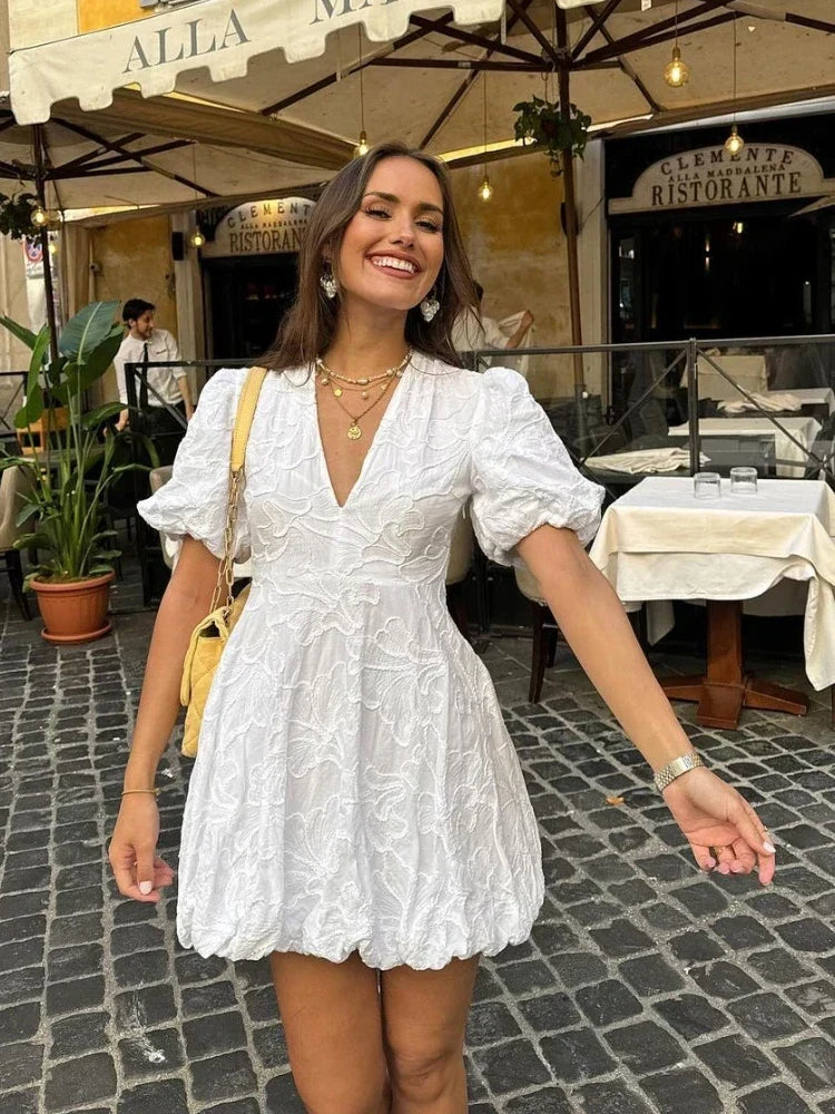 Flowy white A-line summer dress with ruffles & embroidery; perfect for elegant casual or holiday feminine fashion.