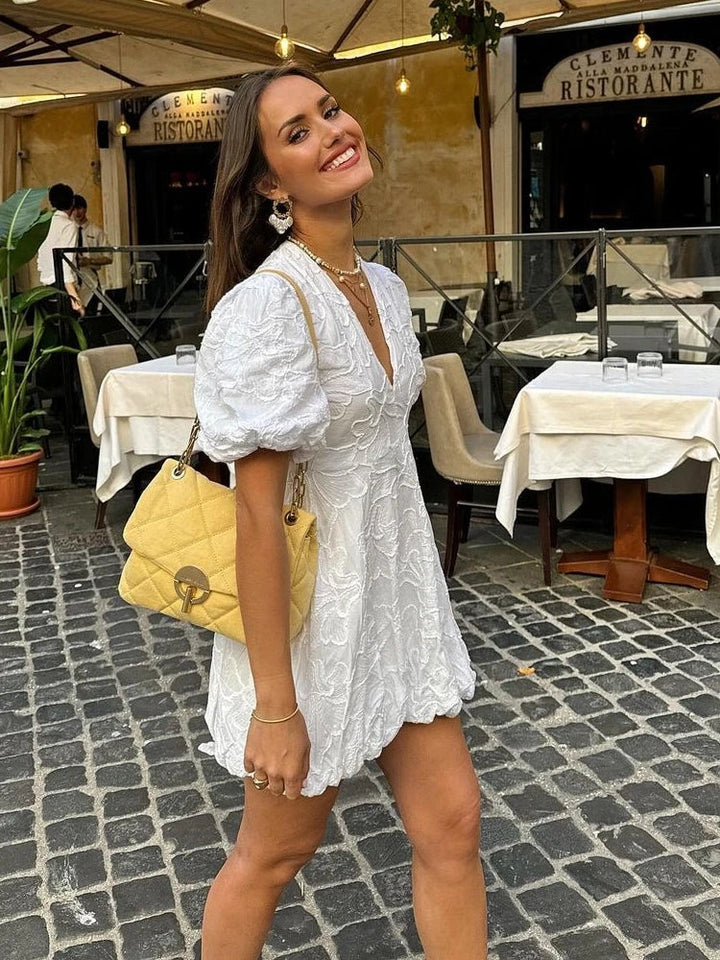 Stylish white embroidered ruffle summer dress, ideal for women's holidays, beach outings, or day-to-night wear.