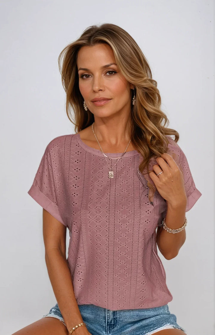 Women's eyelet short-sleeve blouse in white, featuring a sophisticated crew neck & cuffed sleeves.