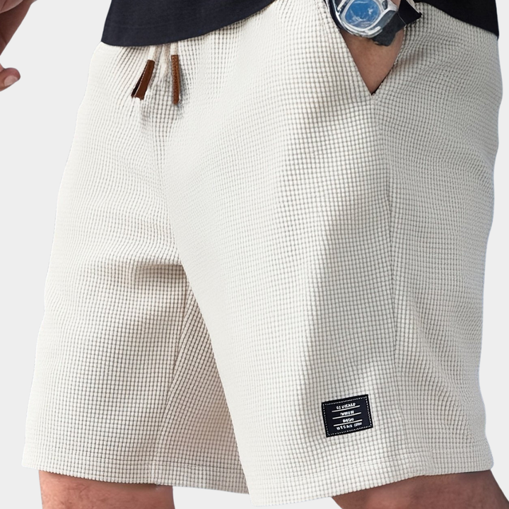 White men's waffle knit drawstring shorts. Relaxed fit for casual summer wear & effortless style.